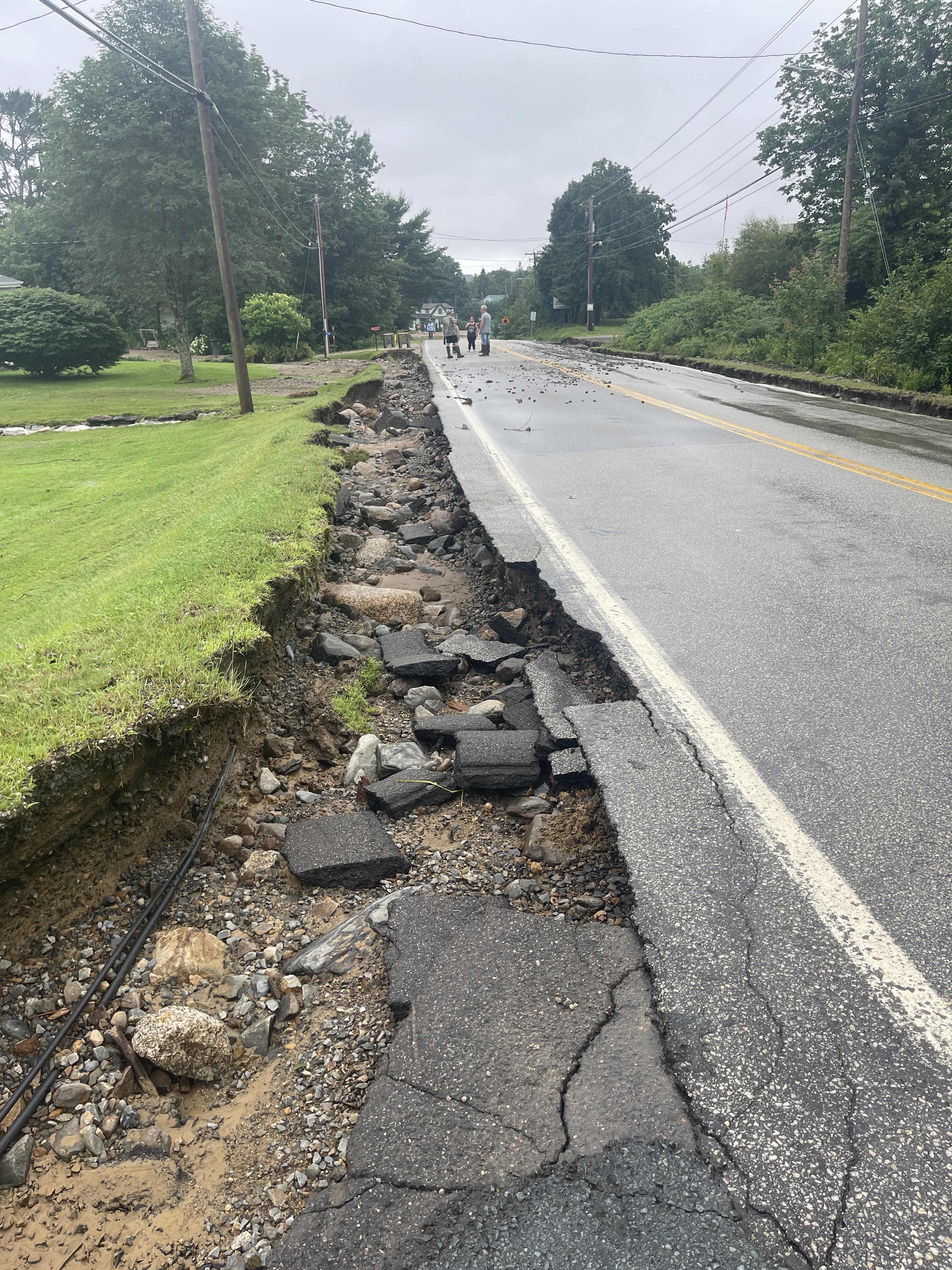 washout on the side of a paved road.