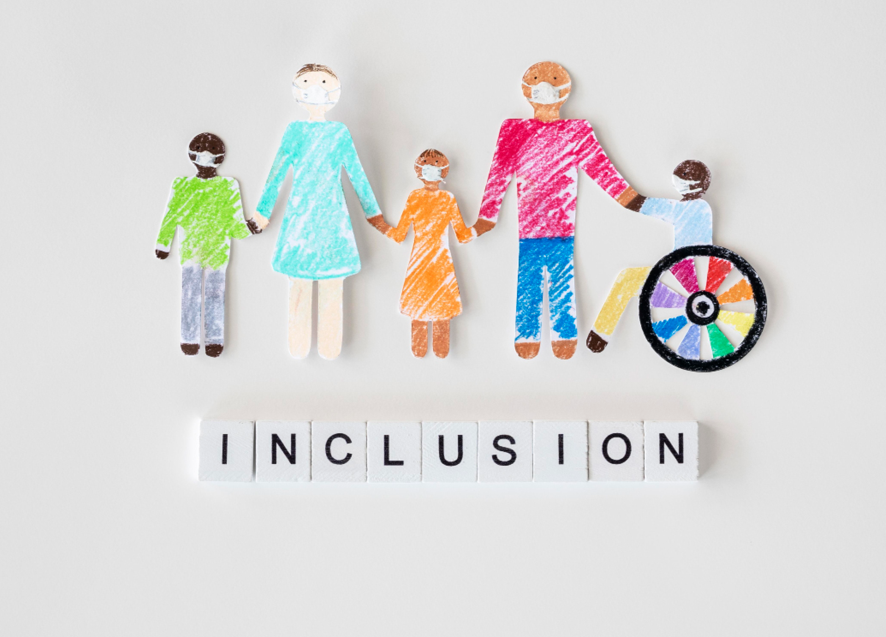 paper cutouts of people holding hands with "inclusion" below them