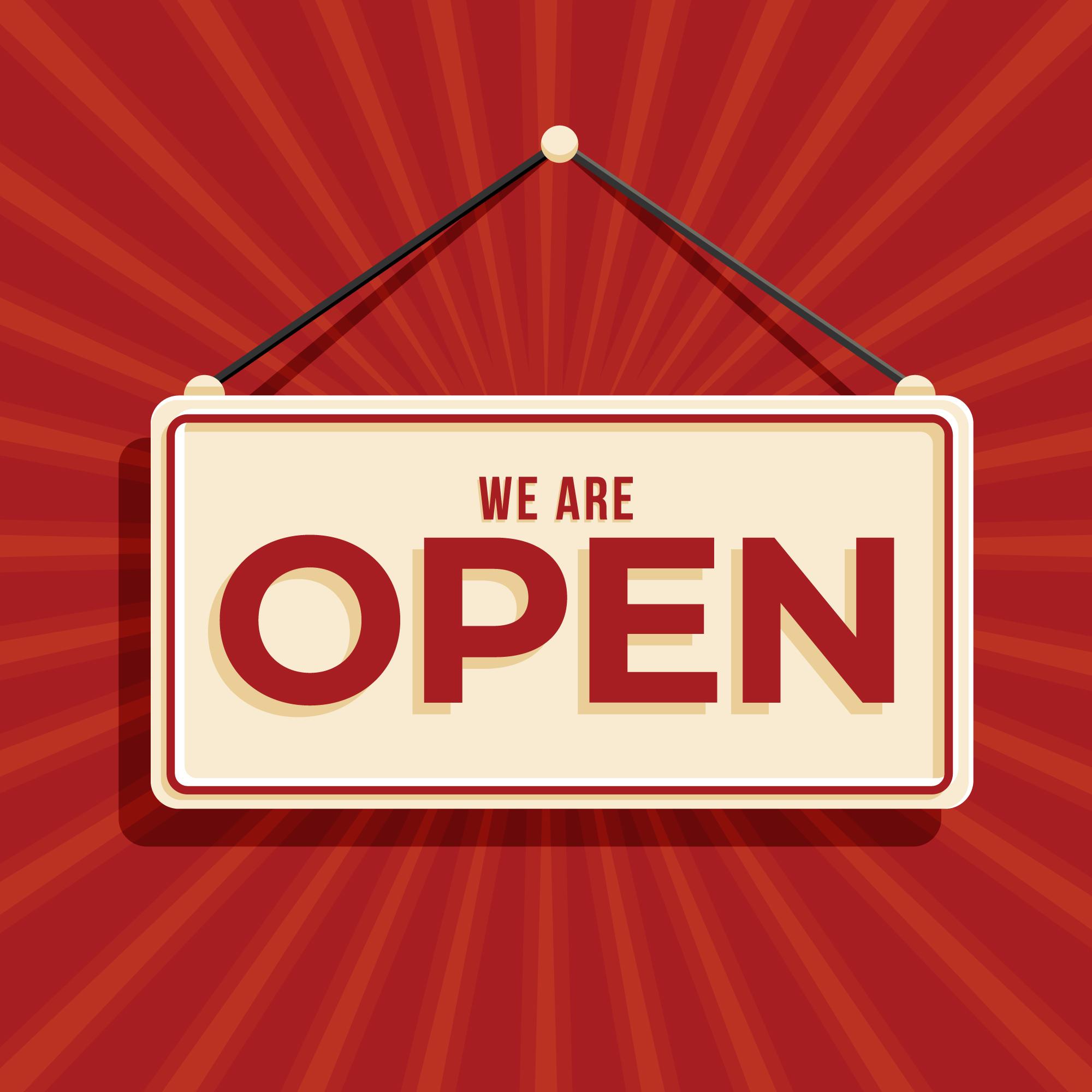 "We're Open" sign hanging on a red sunburst background