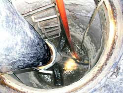 Open manhole with a ladder 