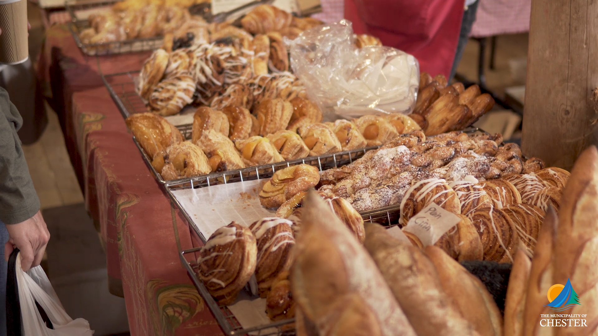 a selection of breads on a table at a farmers' market