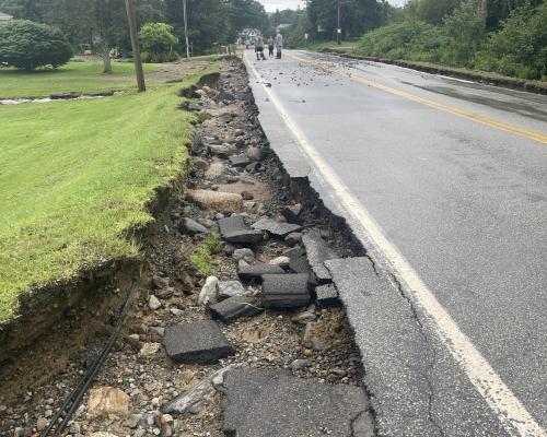 washout on the side of a paved road.