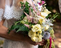 Bride hold her bouquet she created for her wedding. 